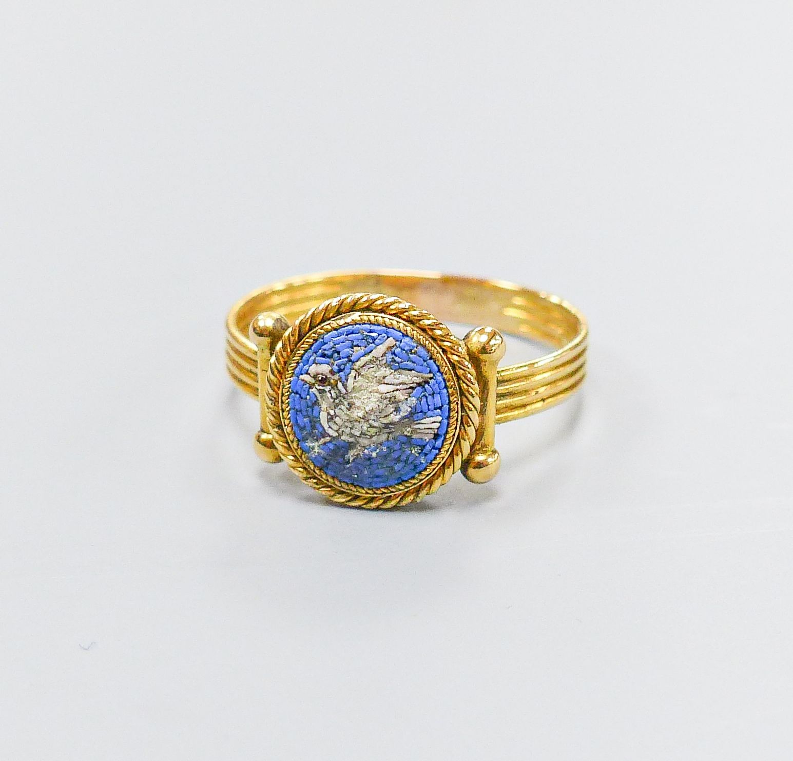 A 19th century Italian? yellow metal and micro mosaic ring, decorated with a dove, size M, gross weight 2.7 grams (a.f.)